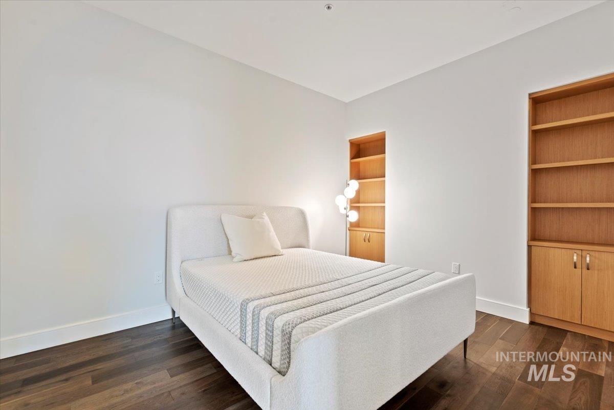 419 South 8th Street, Unit 309 Boise, ID 83702 - Photo 14 of 28 Bedroom with baseboards and dark wood-style flooring