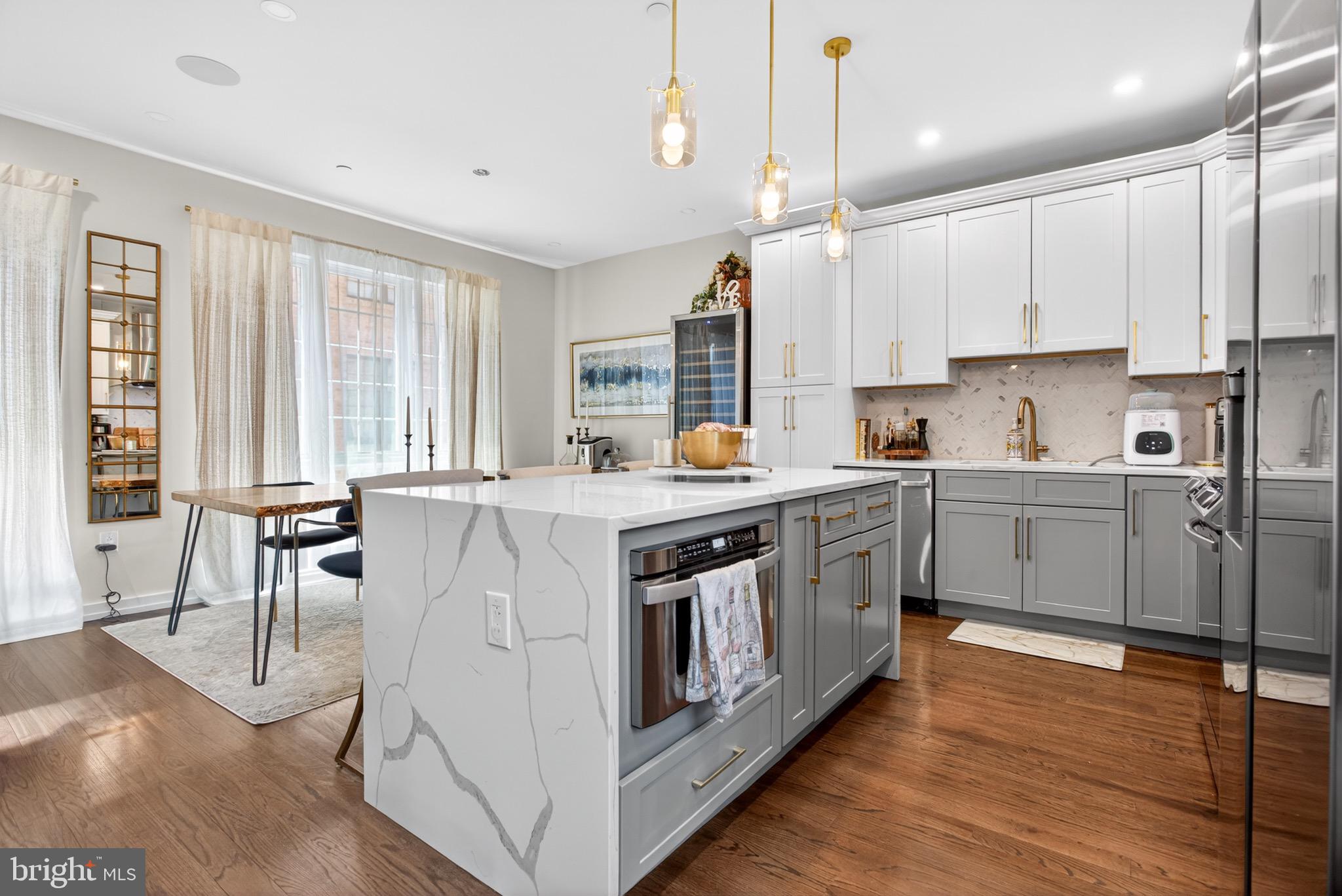 2411 Innovator Way Philadelphia, PA 19146 - Photo 8 of 26 a kitchen with stainless steel appliances granite countertop a stove a sink dishwasher a refrigerator and white cabinets with wooden floor