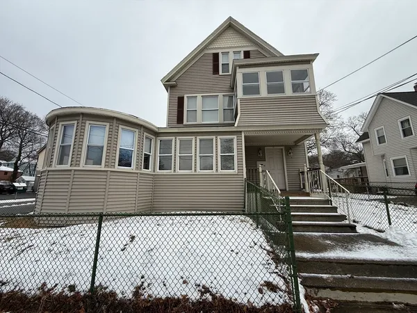 a front view of a house with a garden