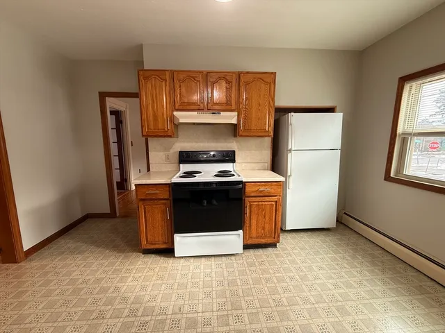 a kitchen with stainless steel appliances a refrigerator stove and microwave