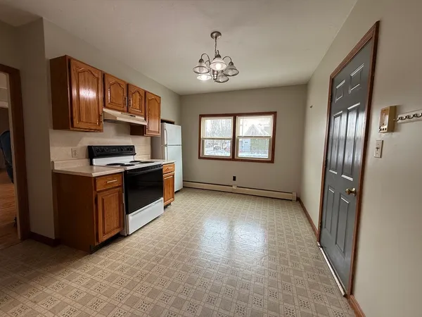 a kitchen with stainless steel appliances granite countertop a refrigerator a stove top oven a sink and dishwasher