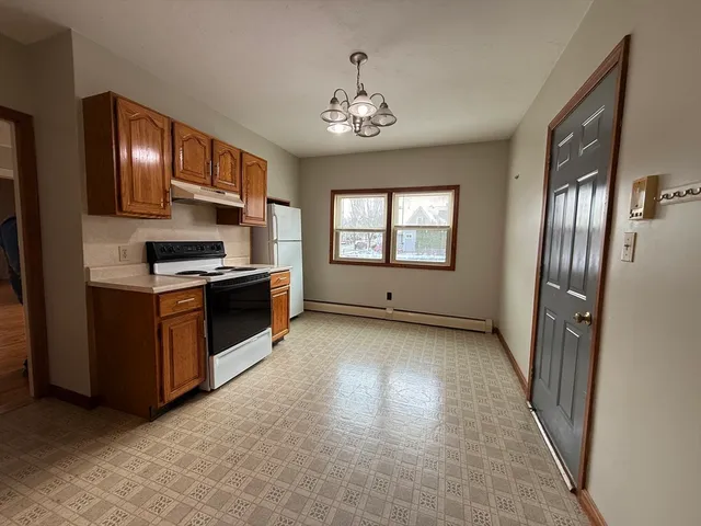 a kitchen with stainless steel appliances granite countertop a refrigerator a stove top oven a sink and dishwasher