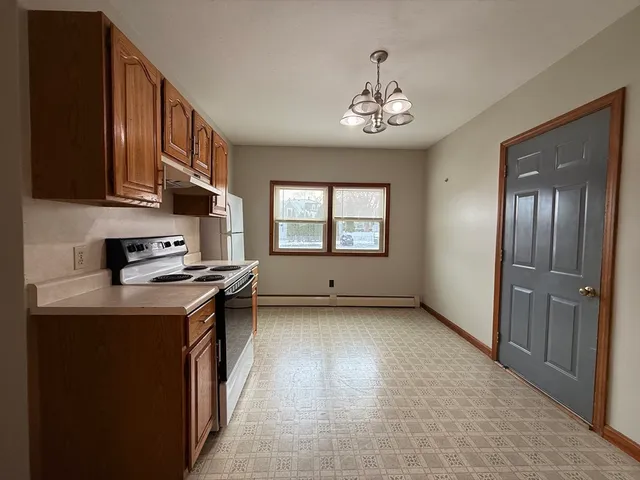 a kitchen with a stove a sink and a refrigerator