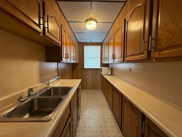 a kitchen with a sink and a refrigerator