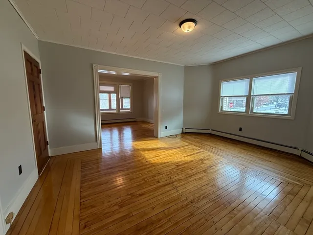 wooden floor in an empty room with a window