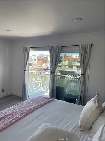 a bedroom with a bed and a large window