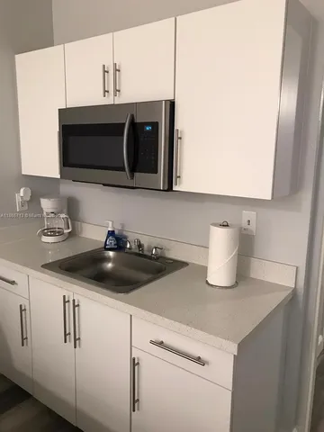 a kitchen with sink and cabinets