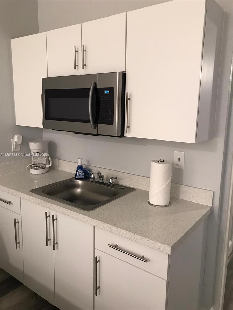 a kitchen with sink and cabinets