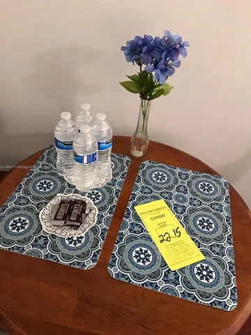 a table with a vase and flowers on it