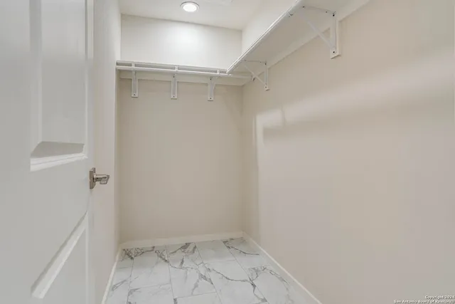 a view of a backyard with wooden fence and large trees