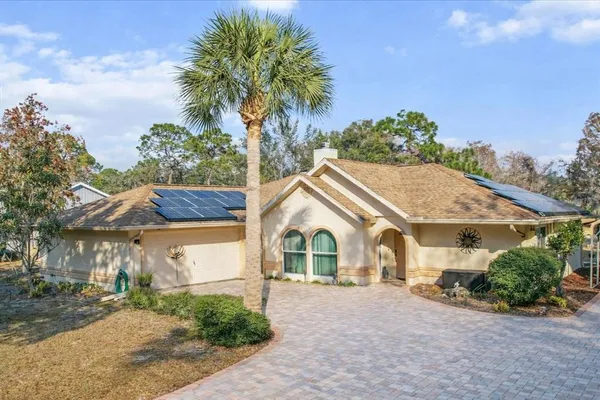 a view of house with outdoor space and garden