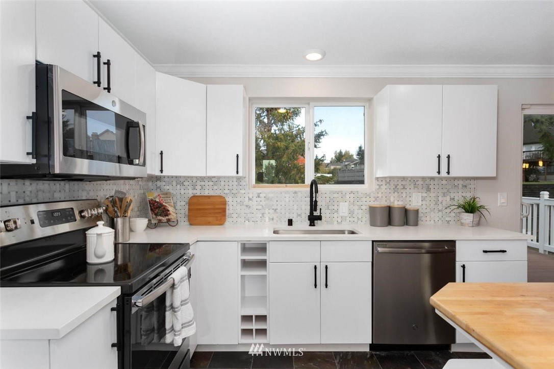 456 Edmonds Court Northeast Renton, WA 98056 - Photo 8 of 25 a kitchen with a sink a stove and cabinets