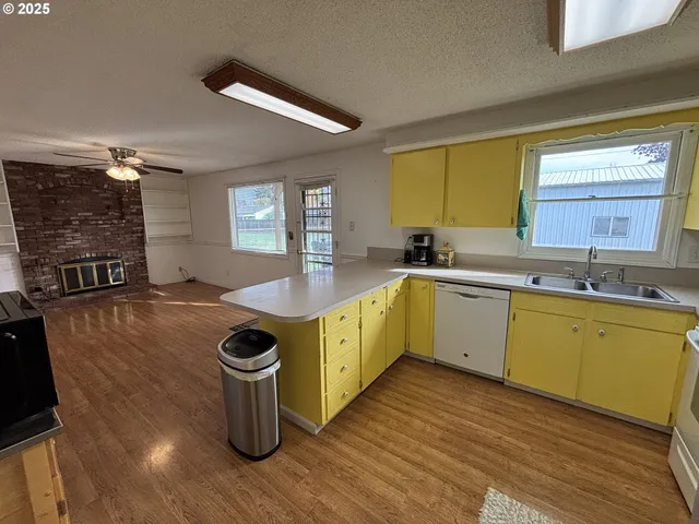 a kitchen with a sink cabinets and wooden floor