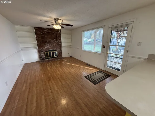 wooden floor in an empty room with a window