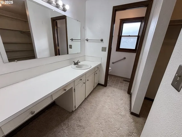 a bathroom with a double vanity sink and mirror