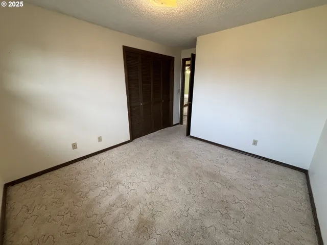 a view of an empty room and closet