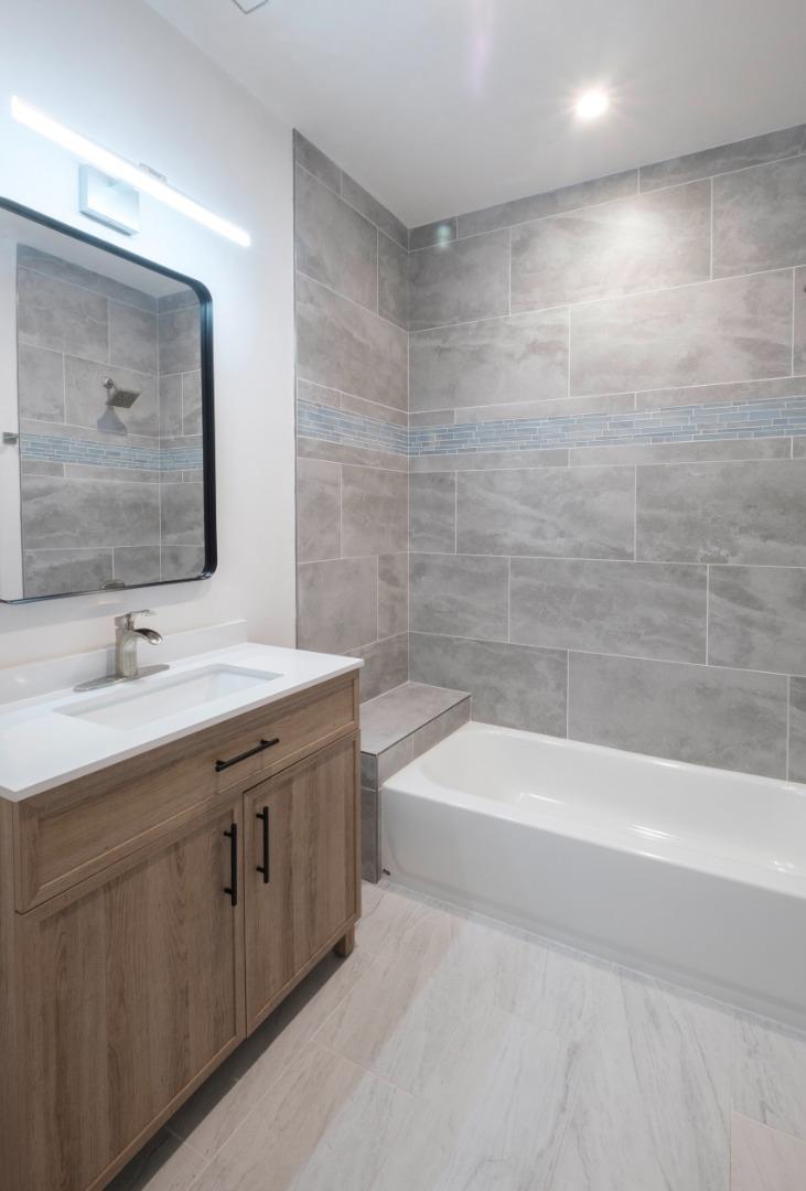 8380 Monterra Views Monterey, CA 93940 - Photo 26 of 45 a bathroom with a tub sink and mirror