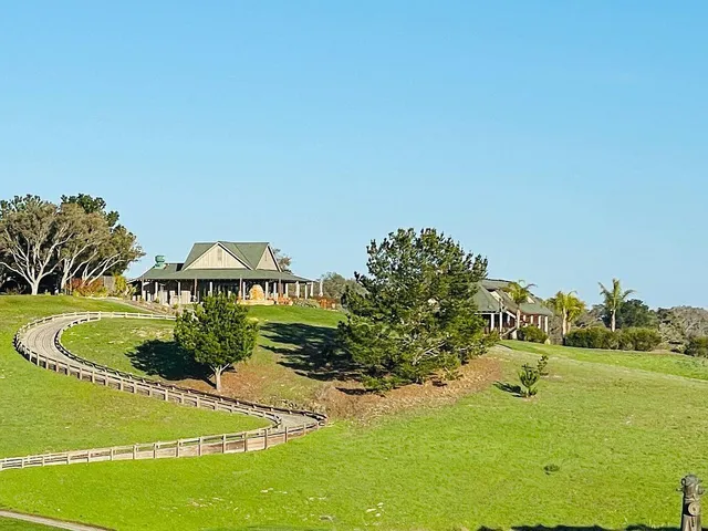 an aerial view of a tennis ground pool patio and mountain view