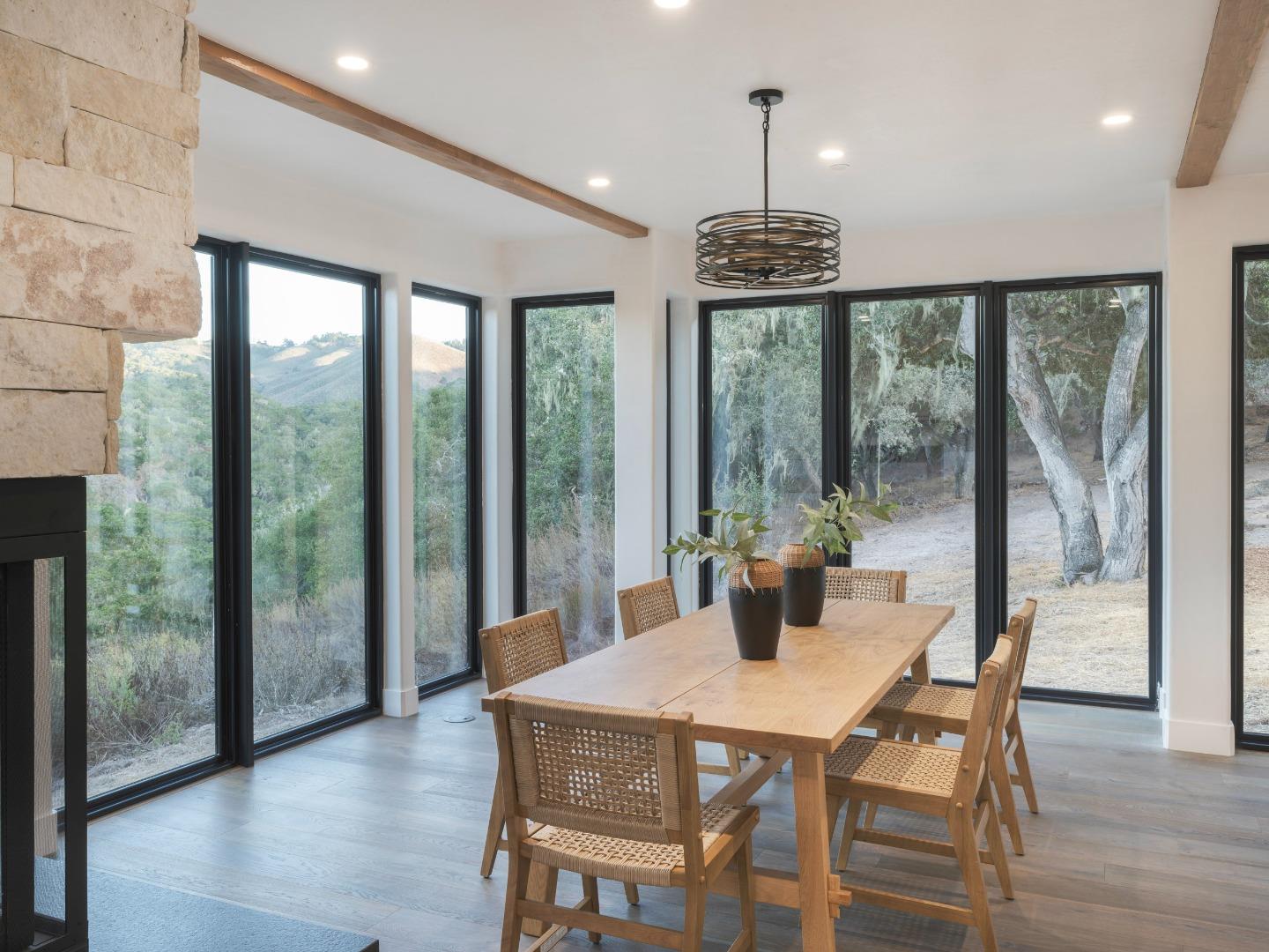 8380 Monterra Views Monterey, CA 93940 - Photo 10 of 45 a dining room with wooden floor a chandelier a glass table and chairs