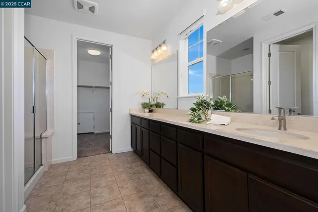 a bathroom with a double vanity sink and a mirror