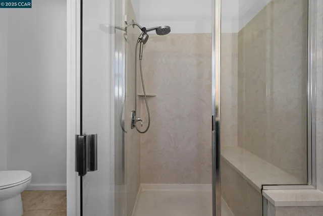 a bathroom with a shower and toilet
