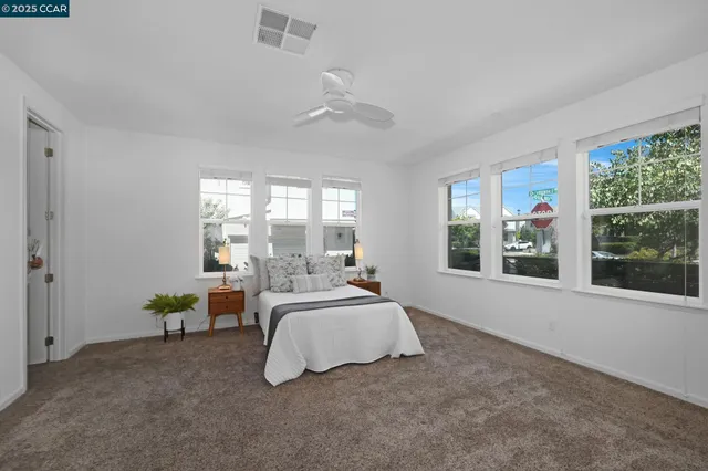 a spacious bedroom with a bed and a large window