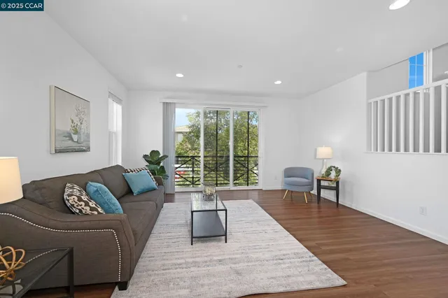 a living room with furniture rug and wooden floor