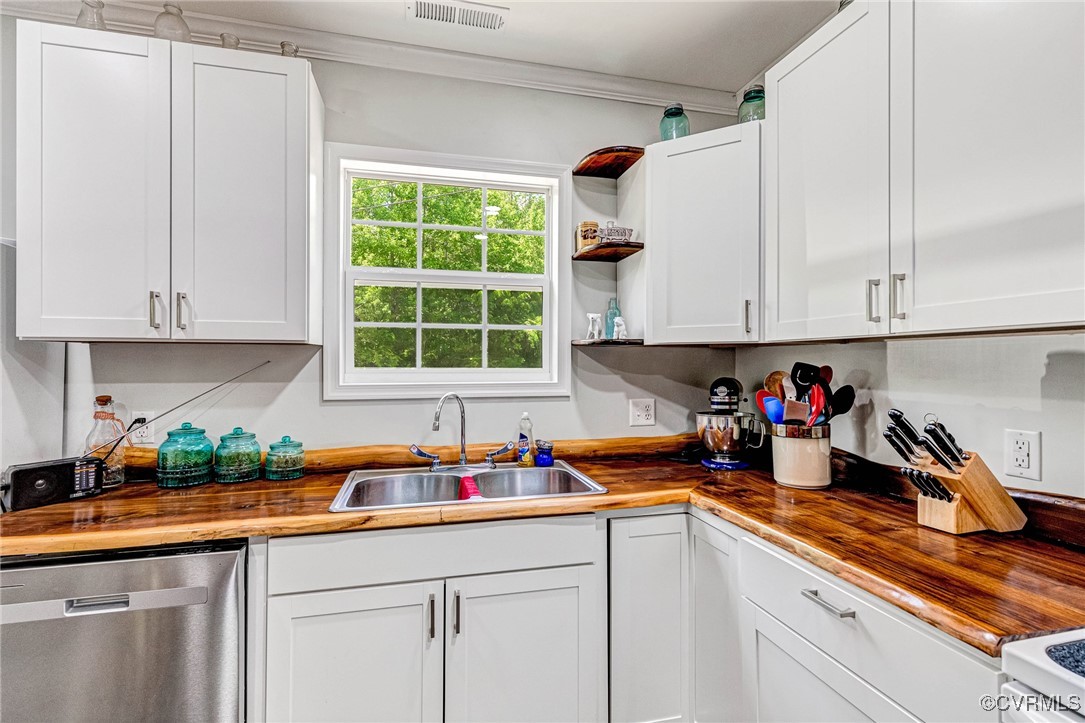274 Regina Road Lancaster, VA 22503 - Photo 11 of 26 a kitchen with stainless steel appliances granite countertop white cabinets sink and a window