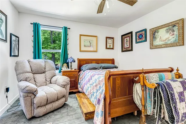 a bedroom with furniture and a window