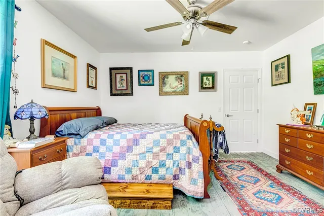 a bedroom with a bed and wooden floor
