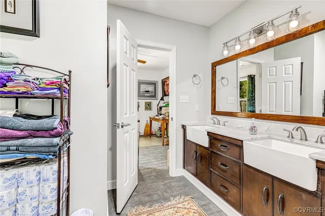 a bathroom with a sink vanity and mirror
