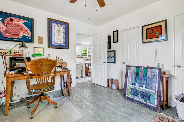 a work room with furniture and a flat screen tv