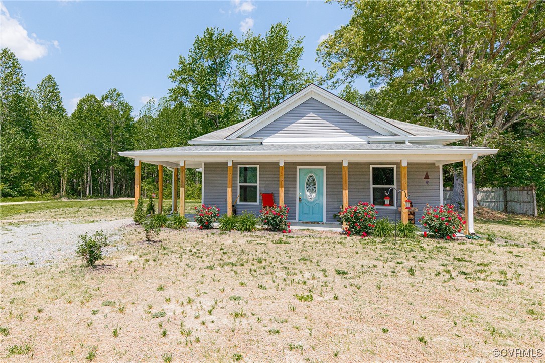 274 Regina Road Lancaster, VA 22503 - Photo 2 of 26 a front view of a house with garden