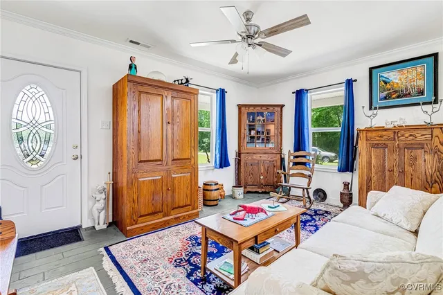 a living room with furniture a rug and a window