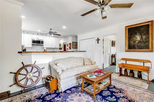 a living room with furniture and kitchen view