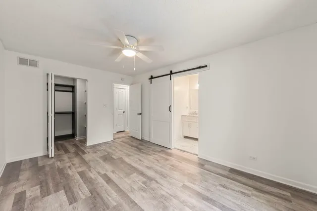 a bathroom with a granite countertop toilet a sink a mirror a shower and a bathtub