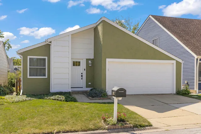 a view of house with backyard and tub