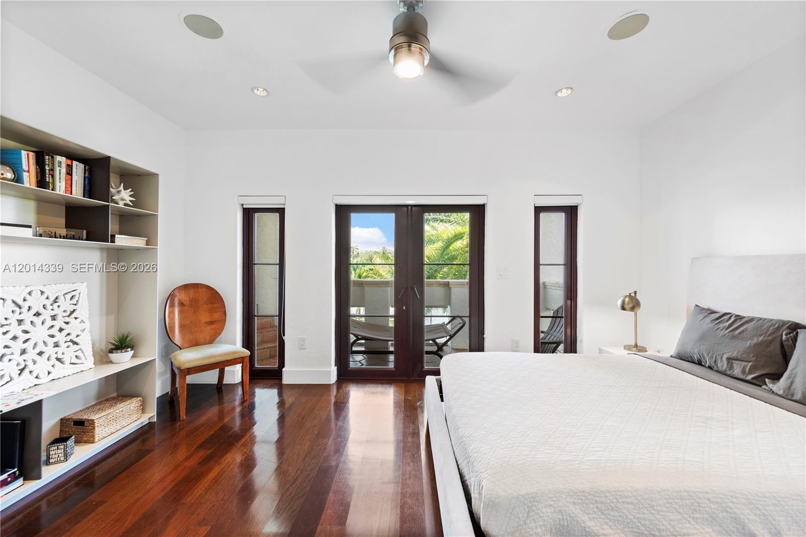 1201 Northeast 83rd Street Miami, FL 33138 - Photo 24 of 42 a bedroom with a bed and wooden floor