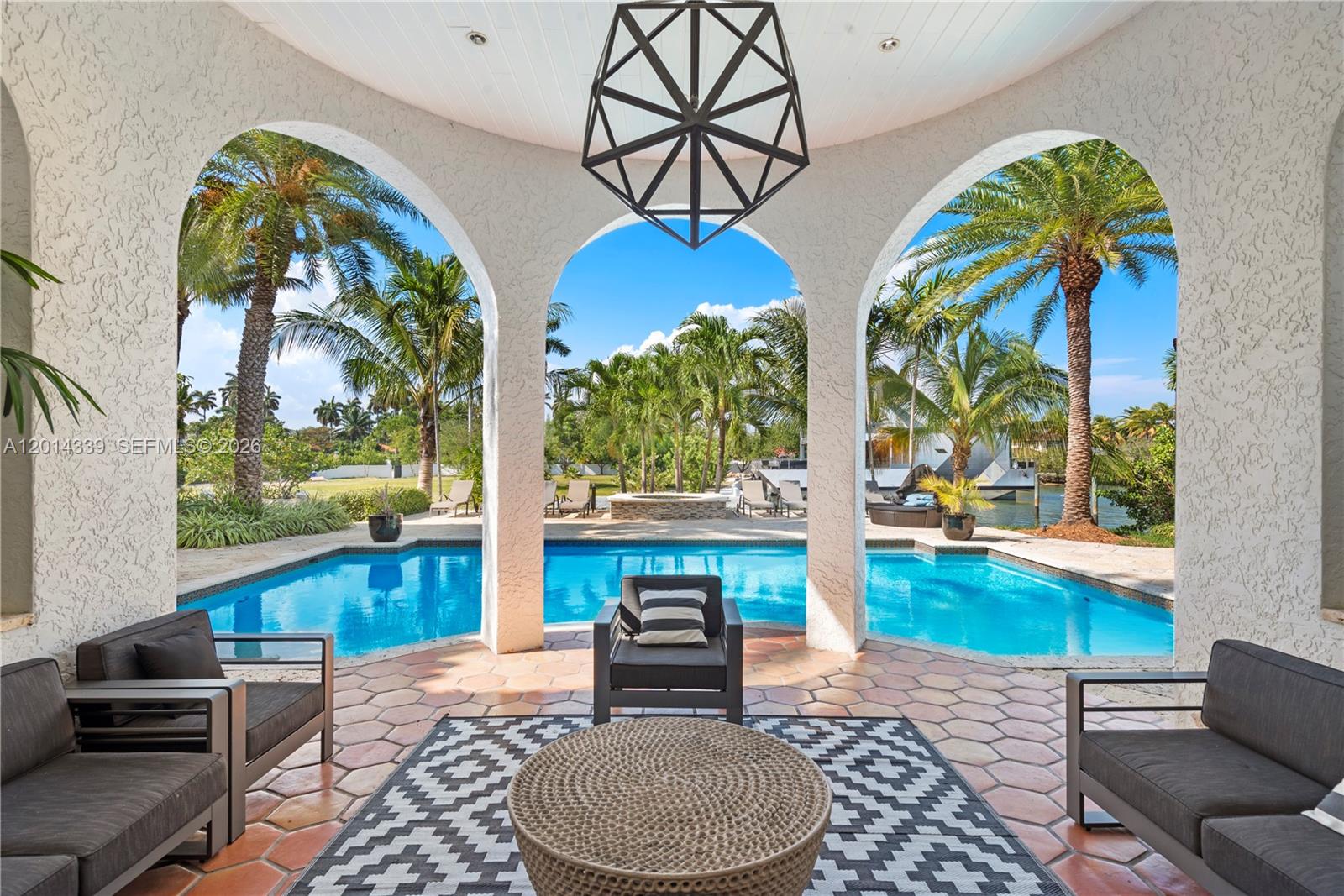 1201 Northeast 83rd Street Miami, FL 33138 - Photo 27 of 42 a living room with fireplace and a floor to ceiling window