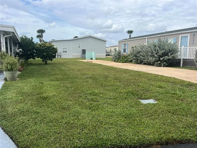 a big yard with lots of green space and plants