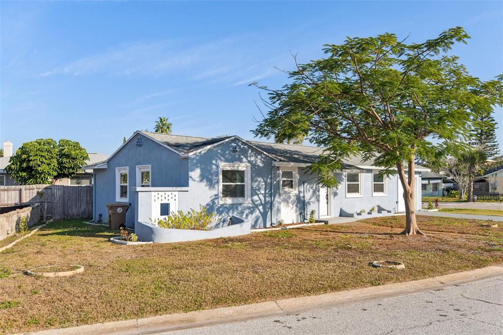 410 Virginia Avenue Madeira Beach, FL 33708 - Photo 3 of 25 a front view of a house with a yard