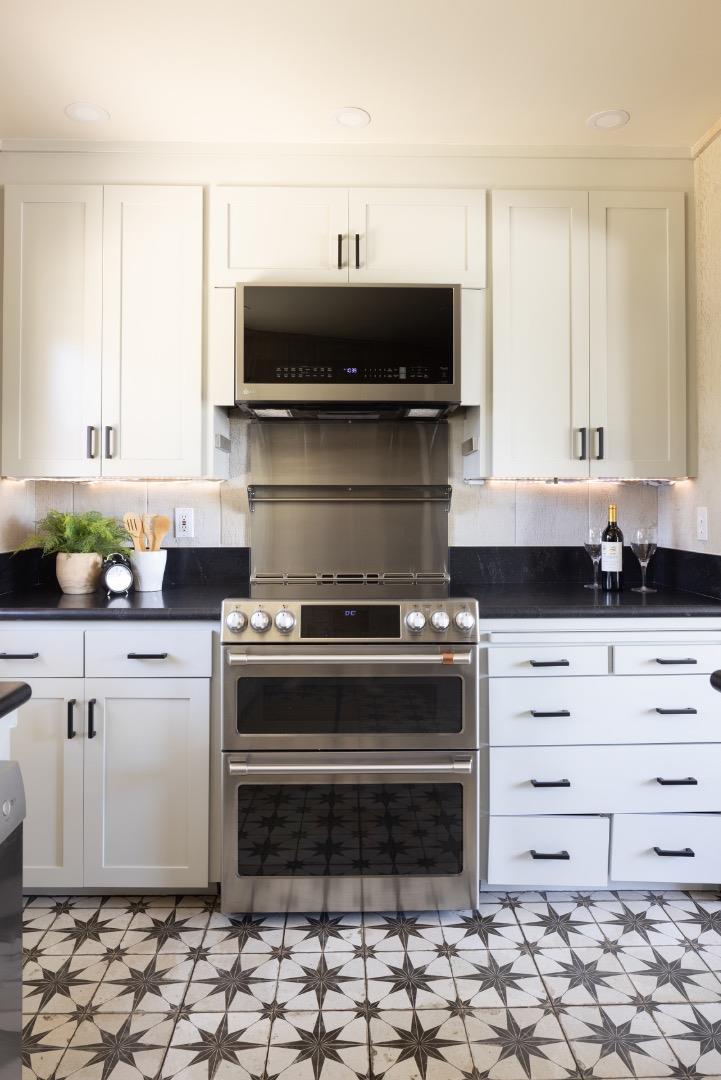 5165 Carmel Valley Road Carmel, CA 93923 - Photo 13 of 19 a kitchen with a stove and white cabinets