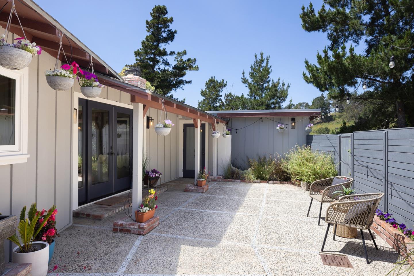 5165 Carmel Valley Road Carmel, CA 93923 - Photo 4 of 19 a backyard of a house with table and chairs potted plants