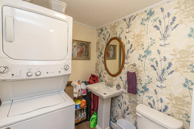 a bathroom with a sink toilet and a mirror