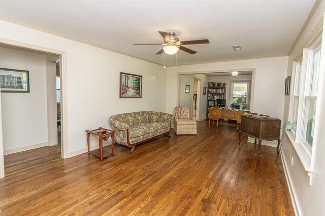 a living room with furniture and a wooden floor