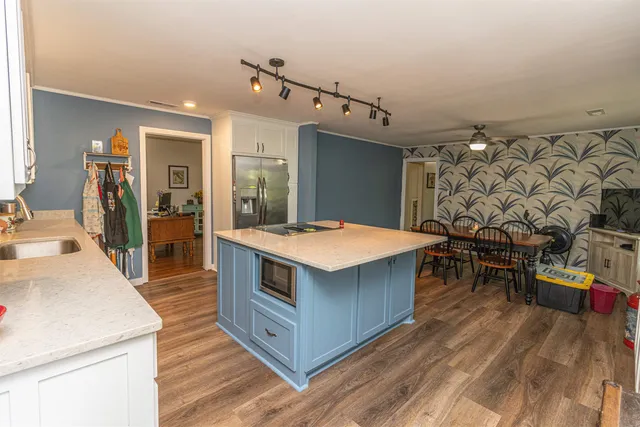 a kitchen with stainless steel appliances granite countertop a sink and a stove