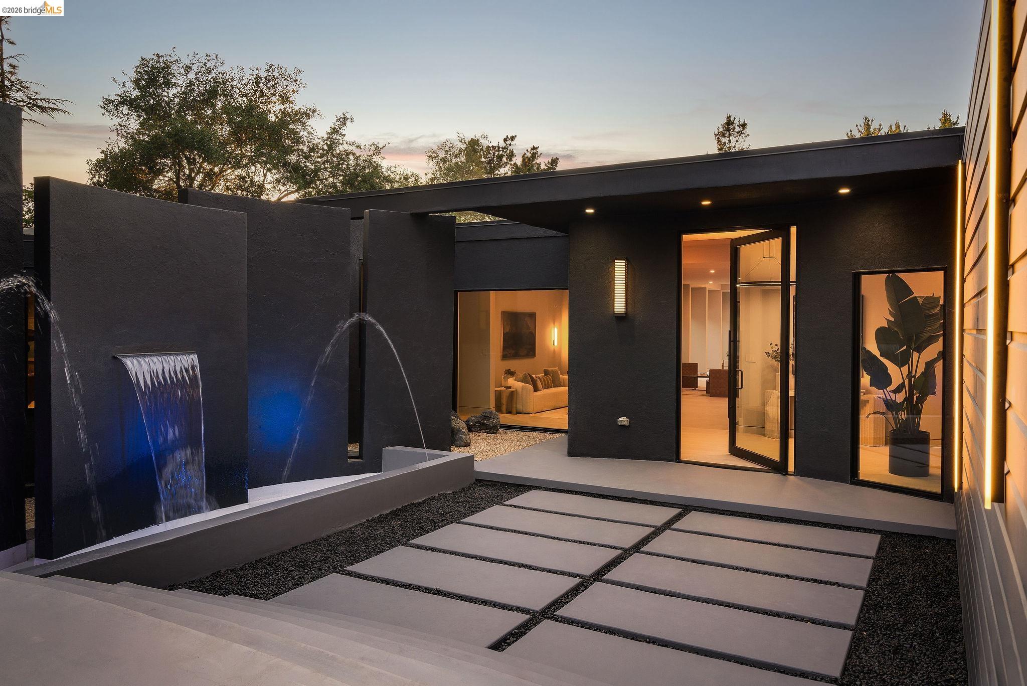 5645 Bacon Road Oakland, CA 94619 - Photo 1 of 94 Modern exterior featuring a prominent water feature with blue accent lighting