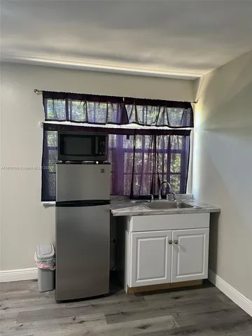 a kitchen with a stove and a refrigerator