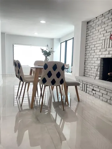 a view of a dining room with furniture and window