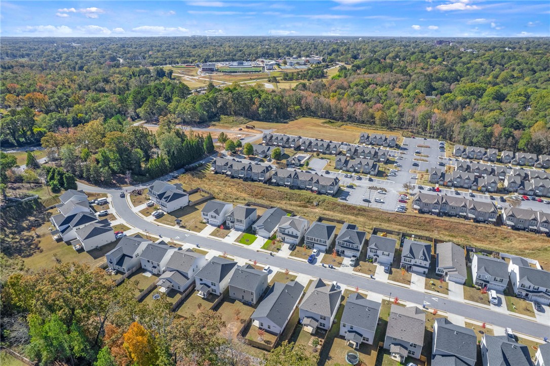 24 Chalet Court Anderson, SC 29621 - Photo 38 of 39 An aerial view showcases a vibrant community nestled among verdant landscapes, offering diverse housing options.